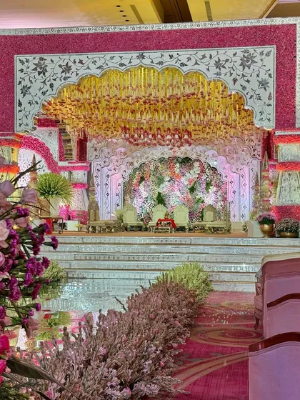 A wide perspective of a mandap that blooms with elegance. The design features fragrant florals, royal seating, and an aura of timeless grace, setting the perfect stage for new beginnings. 🤍
