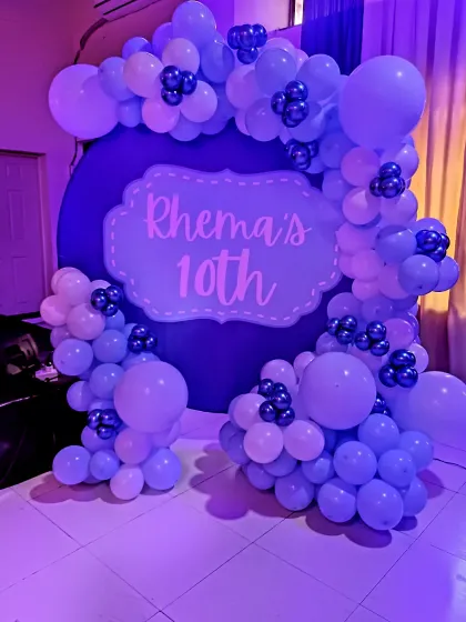 A different angle of the purple-themed 10th birthday setup, showing the texture and detail of the balloon clusters.