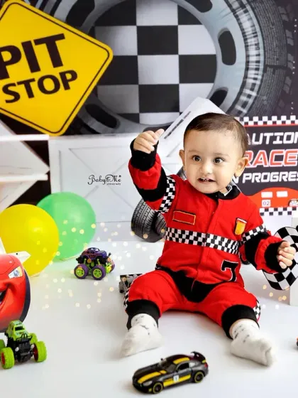 Ready, set, go! For the little one who's always on the move, my race car theme is a total winner. The checkered flags, pit stop signs, and cool cars make for such an energetic and fun first birthday photoshoot.