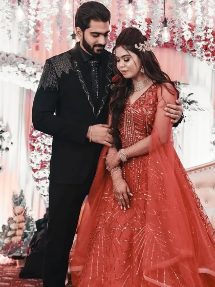 The groom, in his custom Madaan Tailors suit, shares a tender moment with his bride. Our outfits are designed to make your special day even more memorable.
