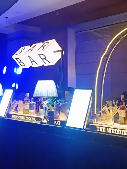 A sophisticated bar setup under blue lighting, featuring our signature 'BAR' block sign and illuminated arches for a modern, club-like feel.