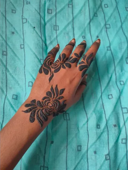 A bold, black-and-white style floral design. This is fresh paste, which gives it that dark, dramatic look before it's removed.