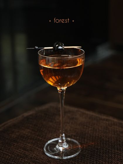 The Forest cocktail is an evocative and complex drink. It combines aged whisky with green apple citrus cordial, raisins, and a pinewood tea syrup. The result is a smoky, woody, and slightly sweet cocktail that transports you to a forest floor.