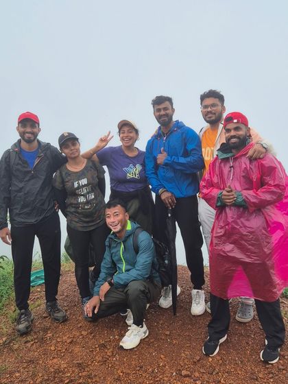 A group of friends posing at the top of Gangadikal peak.
