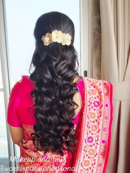 The back view of a half-up style with long, flowing curls. I used a beautiful gold floral clip to secure the hair, adding a touch of elegance to this classic look.