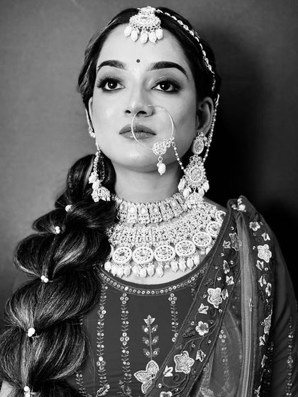 A timeless black and white bridal portrait, focusing on the emotion and the intricate details of the jewelry and hairstyle.