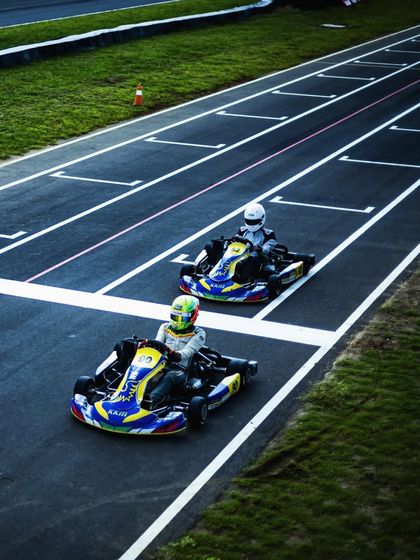 An aerial view of two of our drivers in formation during a practice session, demonstrating teamwork and on-track communication.
