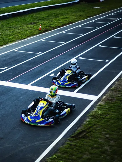 An aerial view of two of our drivers in formation during a practice session, demonstrating teamwork and on-track communication.