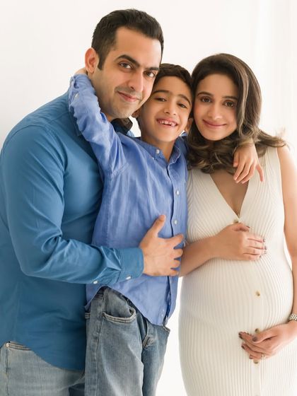 A classic family hug, full of warmth and happiness. This portrait captures the love and excitement of a family of three about to become four.