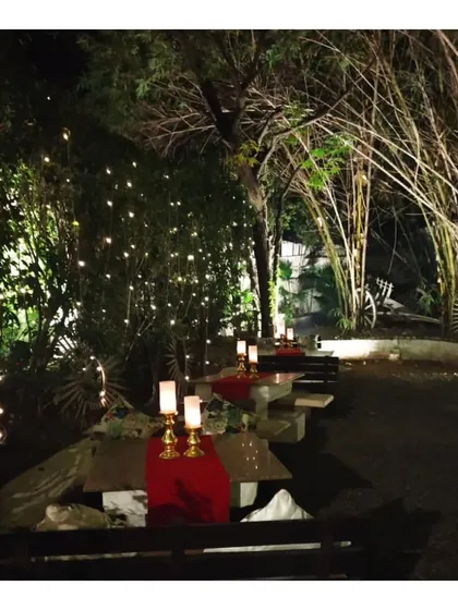 A romantic night time scene at the Garden of Five Senses, with fairy lights and candlelit tables. We work to enhance the natural beauty of a venue to create an unforgettable dining atmosphere.