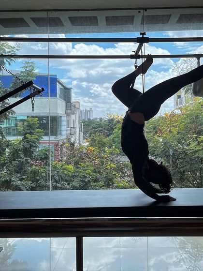 Every day is a great day for Pilates. This handstand variation on the Cadillac is a powerful way to challenge your body and clear your mind.