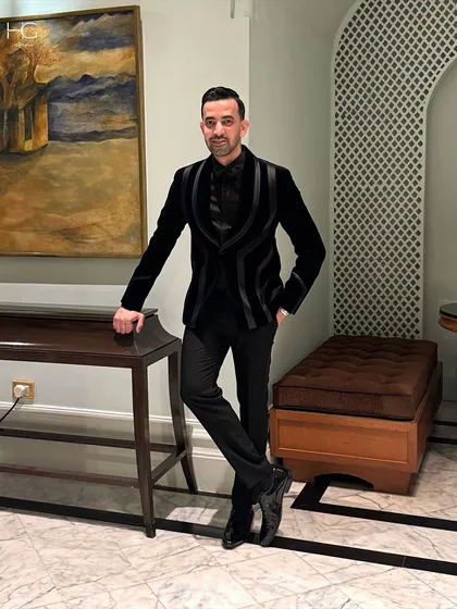 For Ali's celebration, I crafted this black velvet tuxedo. The structured satin lapels create a sharp, powerful silhouette, perfect for a black-tie event or reception.
