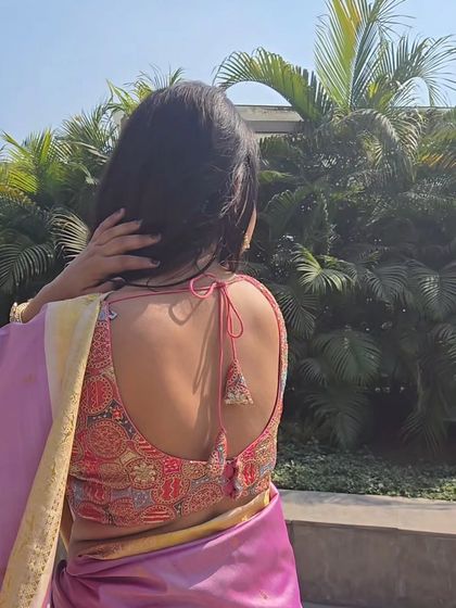 A detailed shot of the intricate blouse I paired with the pink saree. Choosing the right blouse is key to personalizing a saree look, and I love finding unique pieces that complement the drape.