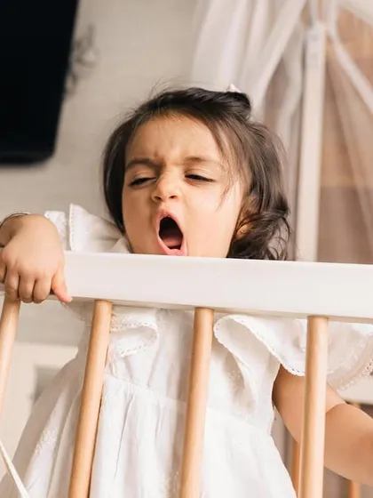 A real moment from a one-year-old's day, a big yawn in her crib. I love capturing these authentic, unscripted parts of childhood during my in-home lifestyle sessions.