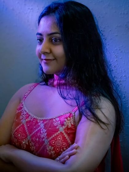 For this indoor bridal shoot, I used dramatic blue lighting to create a cool, modern mood that contrasts beautifully with her traditional pink outfit.