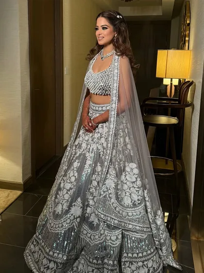 The bride's full lehenga, with her simple half-up hairstyle providing a touch of understated elegance.