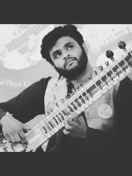 A black and white shot from the Gurupoornima '22 concert, capturing the focused intensity of a live performance.