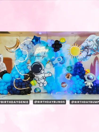 To create an out-of-this-world experience, I designed this immersive space-themed birthday party. The setup features multiple astronaut cutouts, a custom backdrop with planets and stars, and blue and black balloon clouds, all brought to life with neon and LED lighting effects.