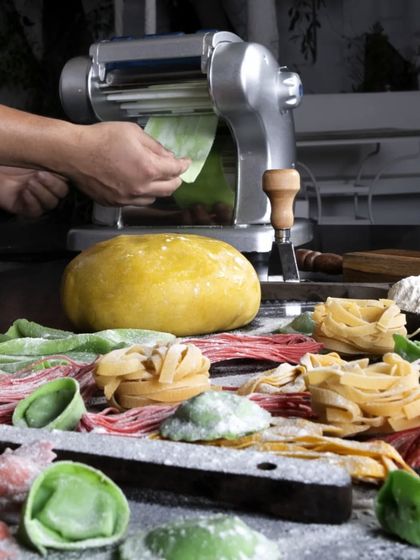 Rolling out fresh pasta sheets and cutting them into various shapes. We offer different types of handmade pasta, from tagliatelle to colourful ravioli.