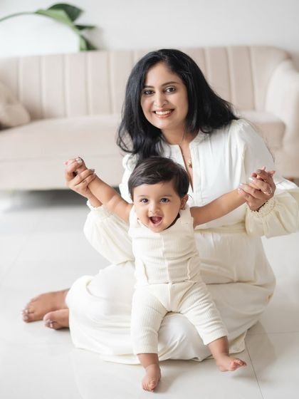 A mother and her baby sharing a joyful moment. The baby's excited expression is just priceless.