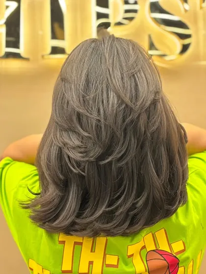 The back view of a layered short haircut, showing the volume and texture created by the expert cutting technique.