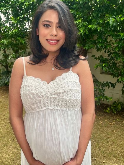 Another beautiful portrait, capturing her serene smile and the soft, dewy finish of the makeup.