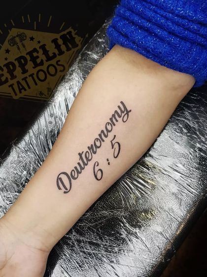 A clean and elegant bible verse script tattoo. Mastering different fonts and ensuring perfect placement are key skills I teach for creating professional script tattoos.