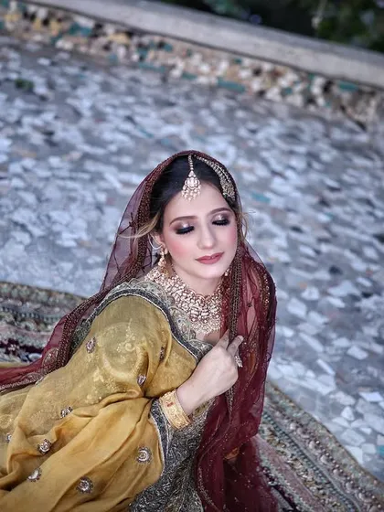 A high-angle shot showing the intricate details of the lehenga and the soft, dreamy makeup of our campaign model.
