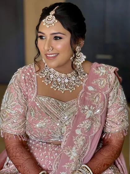 A side profile showing the bride's radiant skin and the elegant way her dupatta is draped.