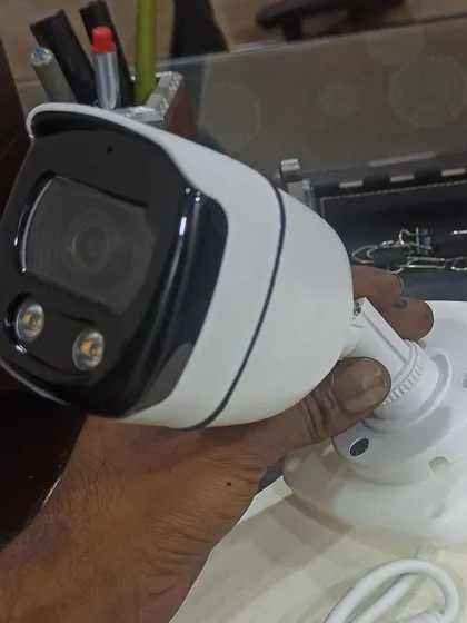 Holding a new bullet camera before installation. We only work with quality hardware to ensure your system is reliable.