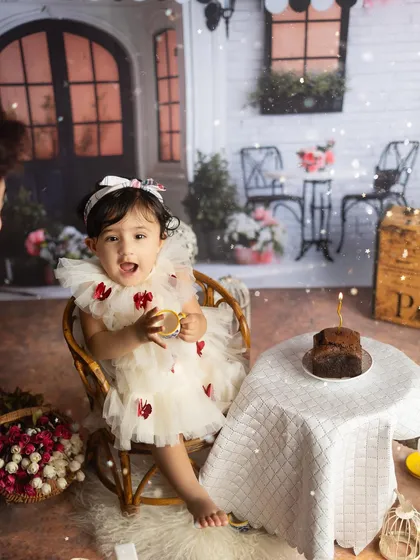 A sweet and playful expression from the birthday girl at her Parisian cafe themed party.