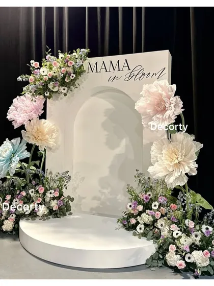 The elegant 'Mama in Bloom' backdrop, showcasing the beautiful arrangement of paper flowers and fresh florals.