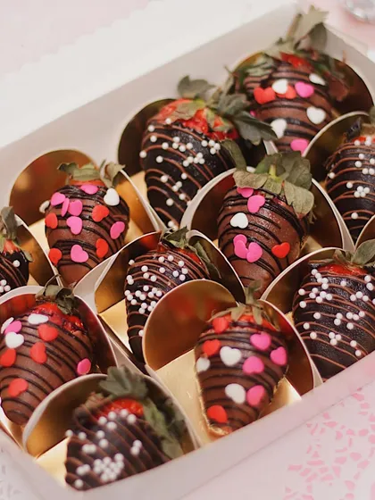 A box of our beautiful chocolate-covered strawberries, decorated with heart-shaped sprinkles. These are a perfect sweet treat for Valentine's Day or any special occasion.
