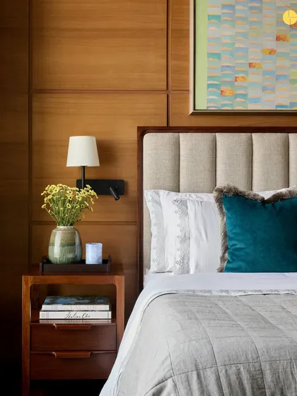 A bedroom should be a sanctuary. For the 'Pad by the Bay' project, we layered textures and warm materials like oak veneer and plush fabrics to create a serene retreat. The space is designed for rest, with curated art and soft lighting completing the calm atmosphere.
