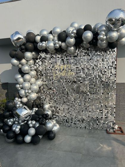 A focused shot of the modern silver and black birthday backdrop, perfect for capturing stylish party photos.