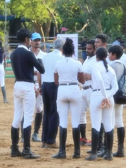 My team discussing strategy at the Auroville Horse Show. Success in this sport is a team effort, involving riders, coaches, and grooms working together.