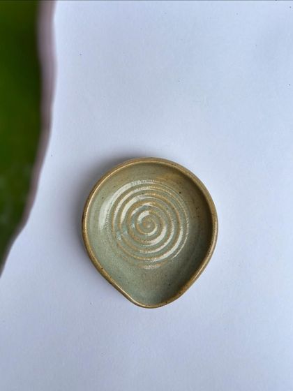 A top-down view of the Chun spoon rest, showing the beautiful spiral and the notch to hold your spoon.