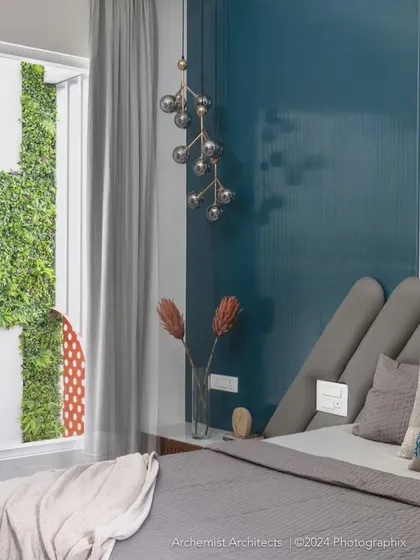 This master bedroom in Dr. Harsha's home is designed as a serene retreat. The room opens up to a private vertical garden, flooding the space with natural light and creating a seamless connection between the indoors and the lush greenery outside.
