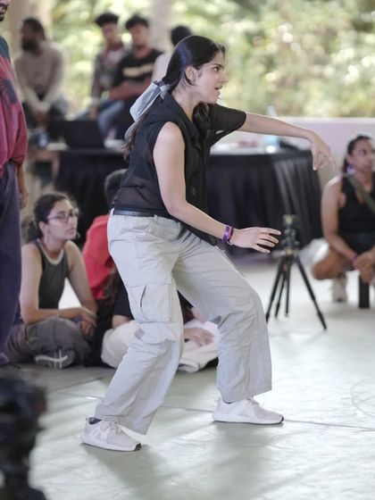 A dancer in the zone during one of the battles at Spectra, showcasing her focus and style.