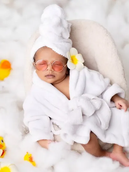 It's a spa day for this little one. I create a relaxing and funny scene with a tiny bathrobe, cucumber slices (or in this case, heart-shaped sunnies), and rubber ducks for a unique and charming baby portrait.
