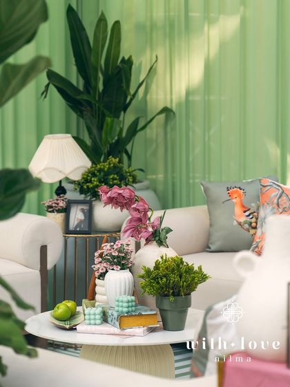 Another view of the cozy lounge seating in 'The Conservatory', with lush plants and soft lighting creating a serene atmosphere.