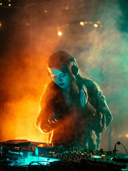 A different angle of me mixing, surrounded by atmospheric smoke and dramatic lighting.