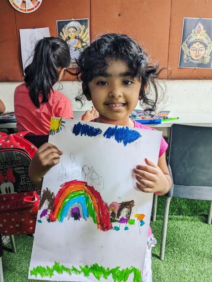 Art is also about pure, uninhibited expression. This very young student created a wonderfully vibrant and imaginative landscape filled with rainbows and color.