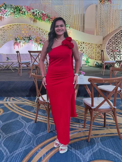 A classic red gown for a grand wedding reception. The elegance of the outfit matched the sophisticated decor of the event perfectly.