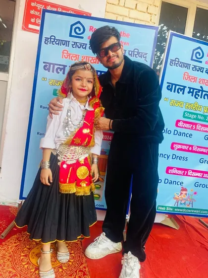 Posing with Navya at the Bal Mahotsav. We support our students at every competition, big or small.