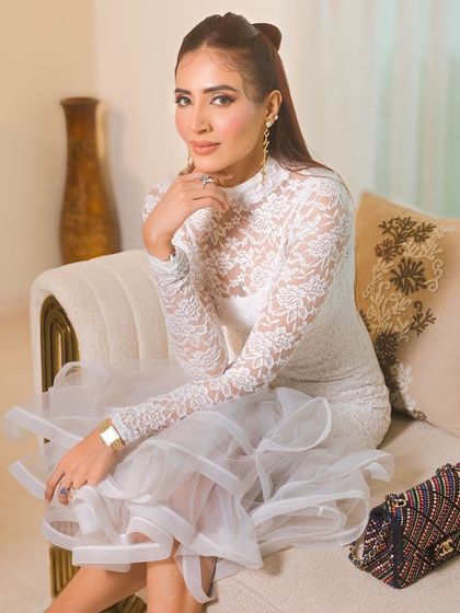 A full shot of the client, her elegant dress and makeup creating a look of modern sophistication.