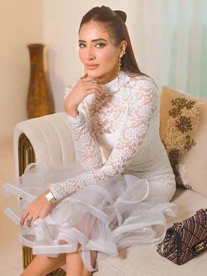 A full shot of the client, her elegant dress and makeup creating a look of modern sophistication.