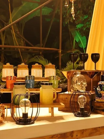 Our bar decor goes beyond just the structure. We use unique props like these skull-shaped glasses and vintage-inspired lanterns to add personality and a quirky touch to a rustic-themed bar.