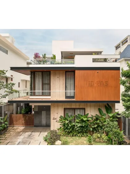 Our architectural work focuses on creating a strong connection with the environment. The facade of the Prakash Reddy residence uses a balanced composition of wood, stone, and glass, surrounded by tropical landscaping to create a modern home that feels integrated with its green surroundings.