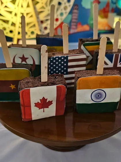 Brownie pops decorated with flags from various countries.